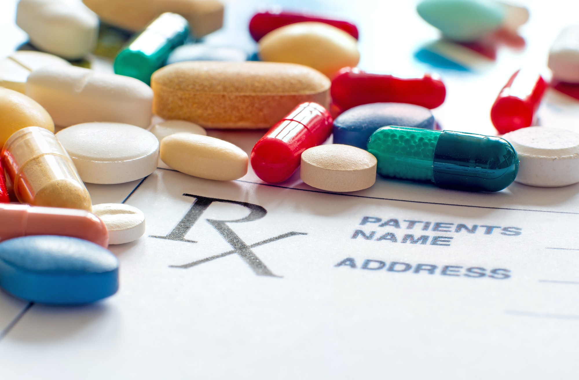 Close up of prescription pills with prescription paper